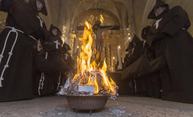 Medio centenar de cofrades estrenaron el Viernes de Dolores la Procesión del Silencio en el interior de una iglesia de San Cosme abarrotada. Al fuego arrojaronel sus oraciones por los fallecidos.  / JESÚS JAVIER MATÍAS