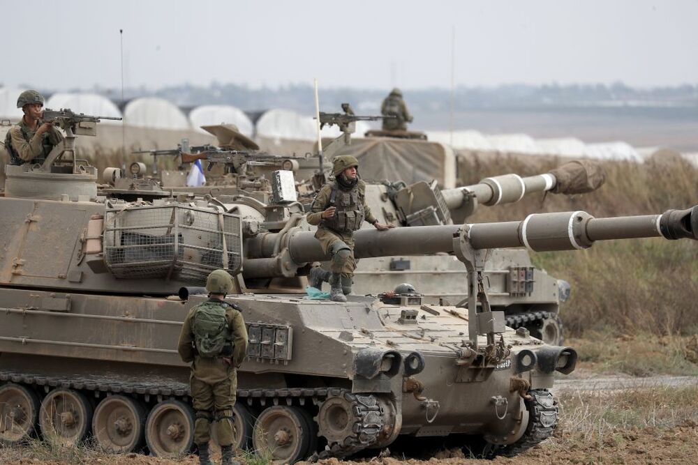 Israeli military tries to strengthen borders with Gaza as battle enters third day  / ATEF SAFADI